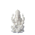 White statue of a seated figure with a lotus flower on a white background