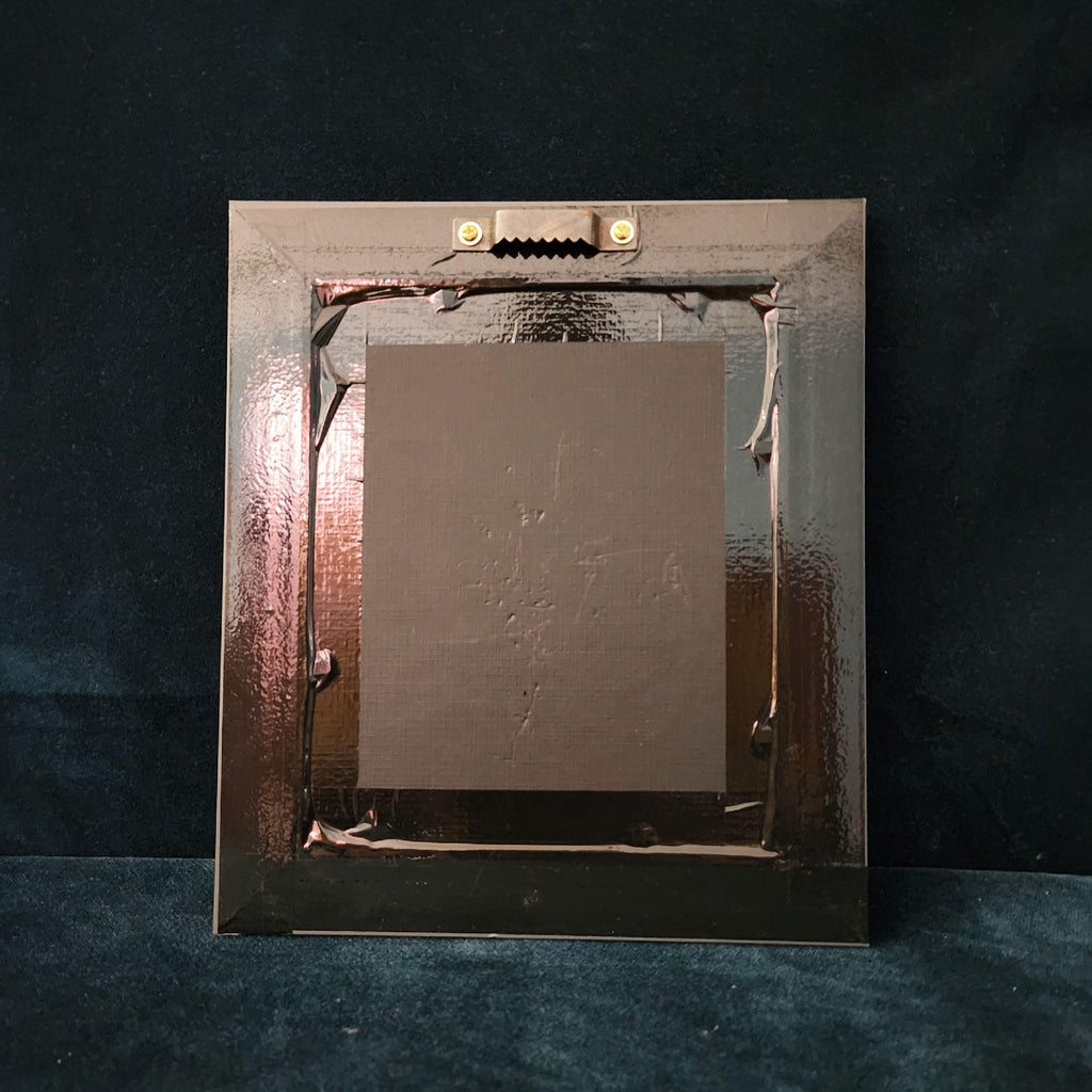 Metallic frame with a textured surface on a dark background