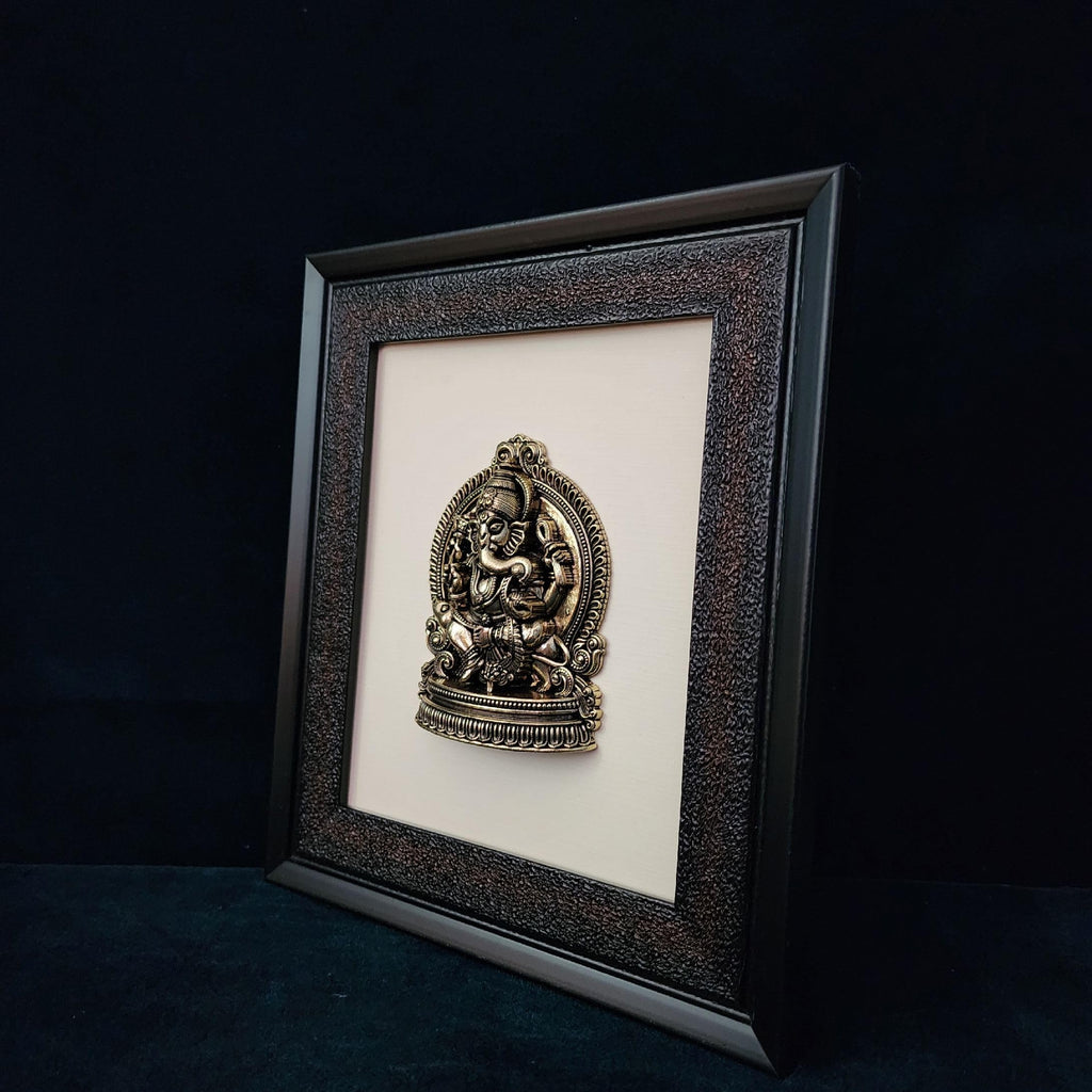 Framed decorative item with a central emblem on a dark background