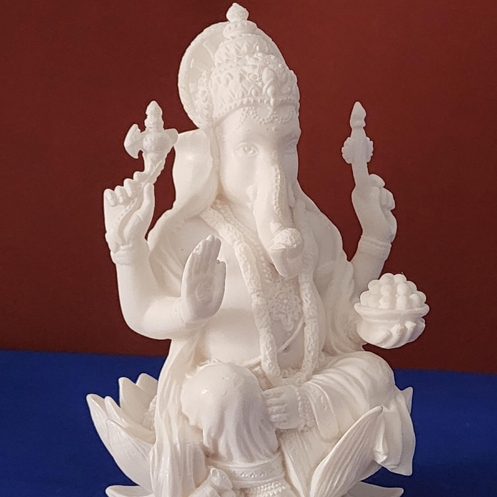 White marble statue of a deity on a red and blue background