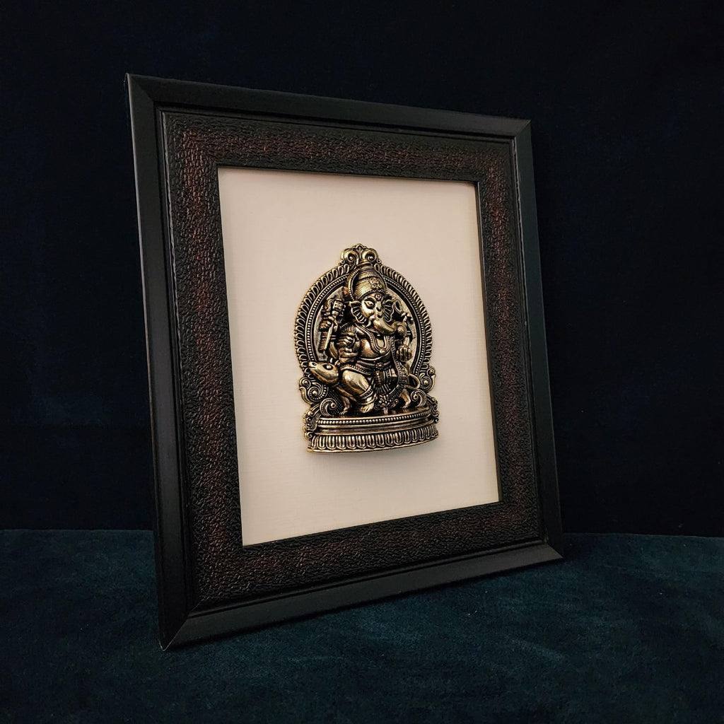 Framed decorative wall art with intricate design on a dark background