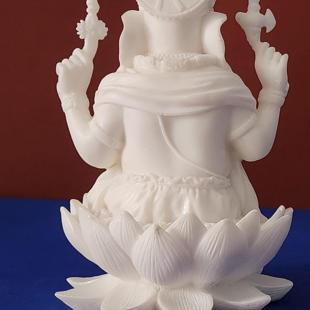 White statue of a deity on a blue and red background