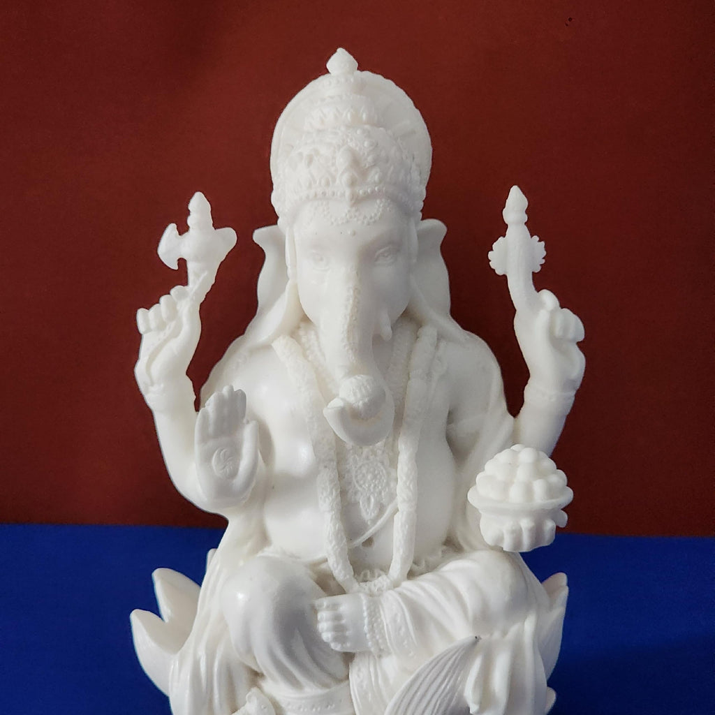 White statue of a deity on a red and blue gradient background